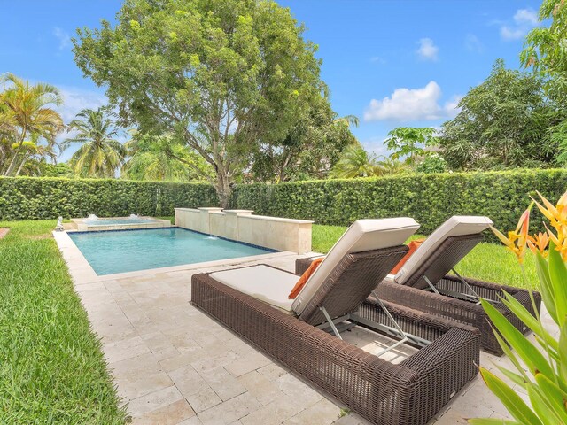 view of swimming pool with a patio and pool water feature