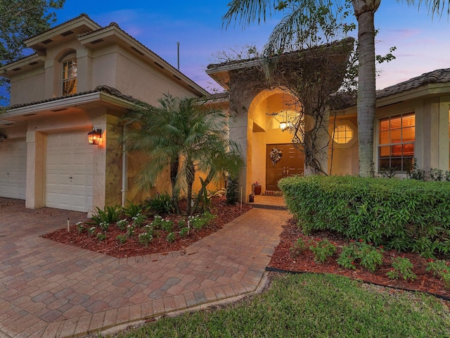 mediterranean / spanish house featuring a garage