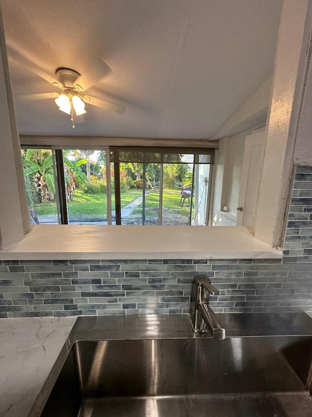 details featuring decorative backsplash, sink, and ceiling fan