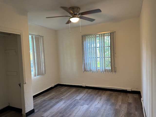 unfurnished room with ceiling fan and dark hardwood / wood-style floors