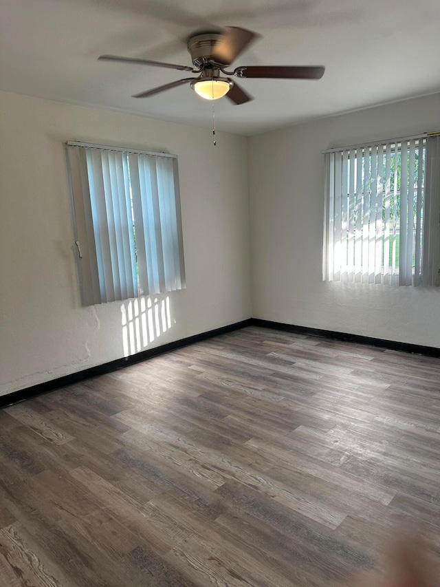 unfurnished room featuring hardwood / wood-style floors and ceiling fan