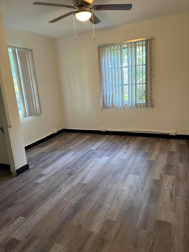 unfurnished room with dark hardwood / wood-style floors and ceiling fan