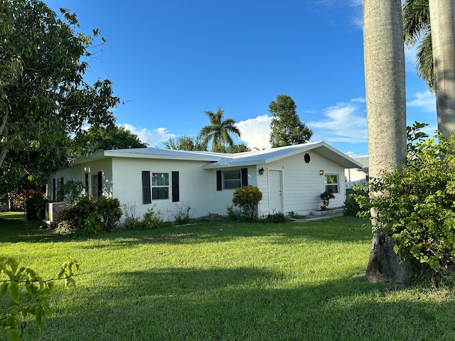 back of property featuring a yard