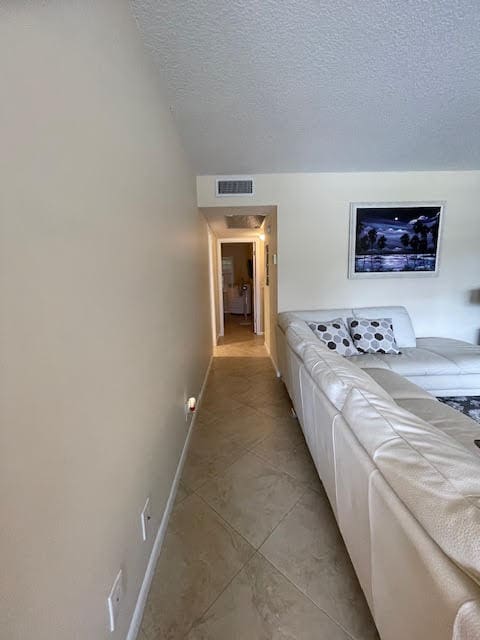 hallway featuring a textured ceiling