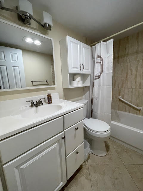 full bathroom with vanity, toilet, shower / bath combination with curtain, and tile patterned flooring