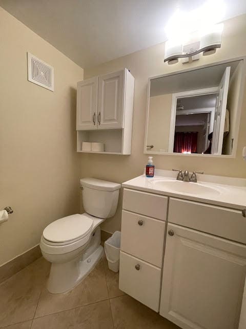 bathroom with vanity, toilet, and tile patterned floors