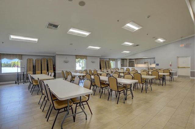 dining space featuring light tile patterned flooring, vaulted ceiling, and plenty of natural light