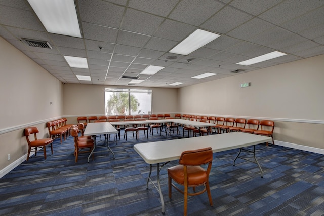 rec room featuring a paneled ceiling and dark colored carpet