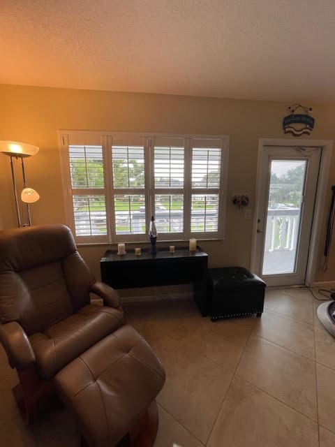 living room featuring a textured ceiling and tile patterned floors