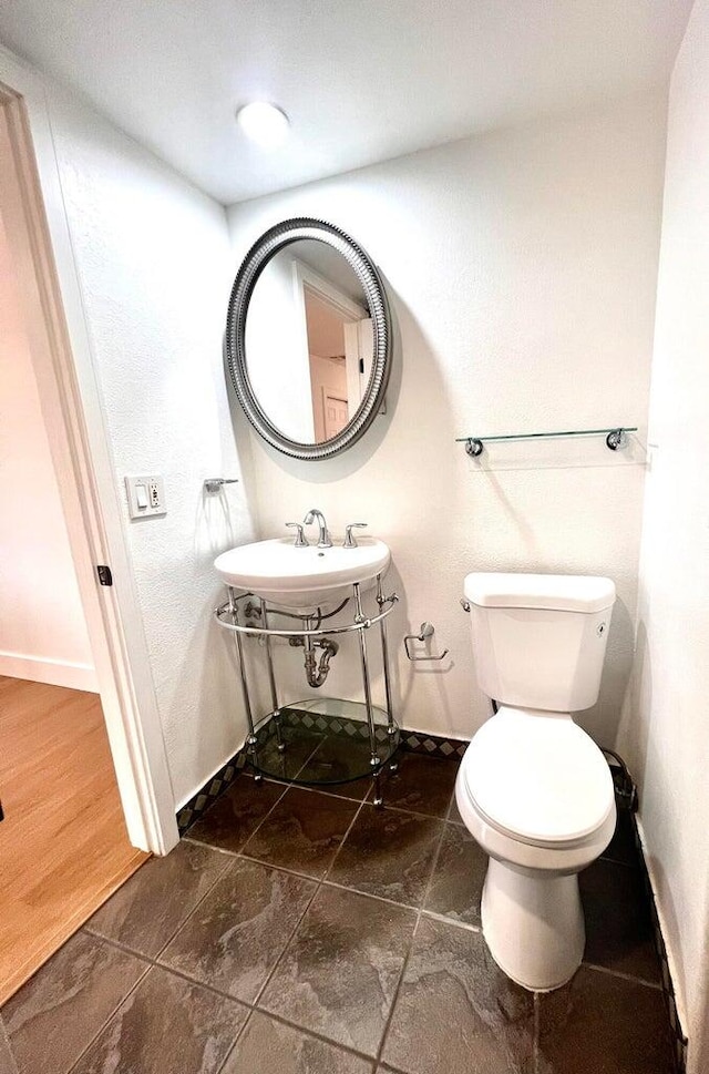 bathroom with sink, hardwood / wood-style floors, and toilet