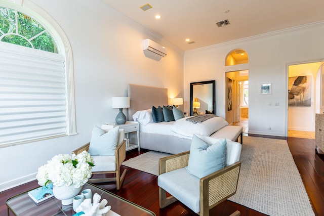 bedroom with ornamental molding, dark hardwood / wood-style flooring, and a wall unit AC