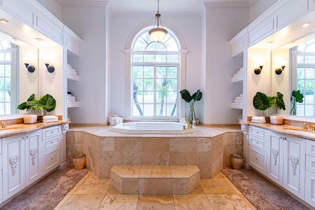 bathroom featuring tiled tub, vanity, and crown molding