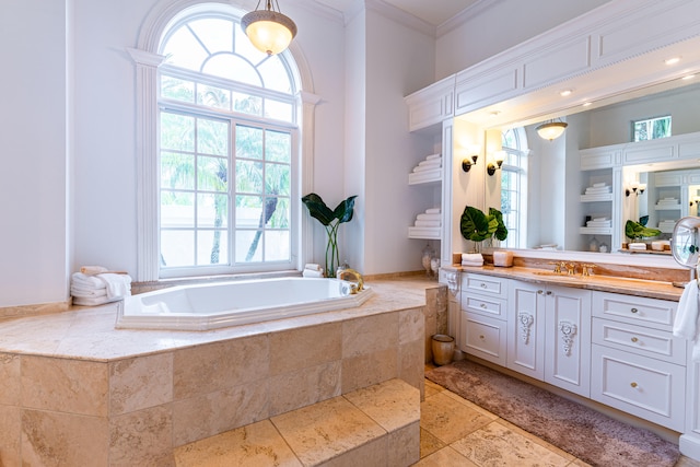 bathroom featuring a relaxing tiled tub, vanity, and crown molding