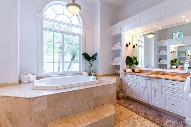 15495 Tall Oak Ave, Delray Beach, FL 33446 - bathroom featuring crown molding, stone tile floors, vanity, and a bath