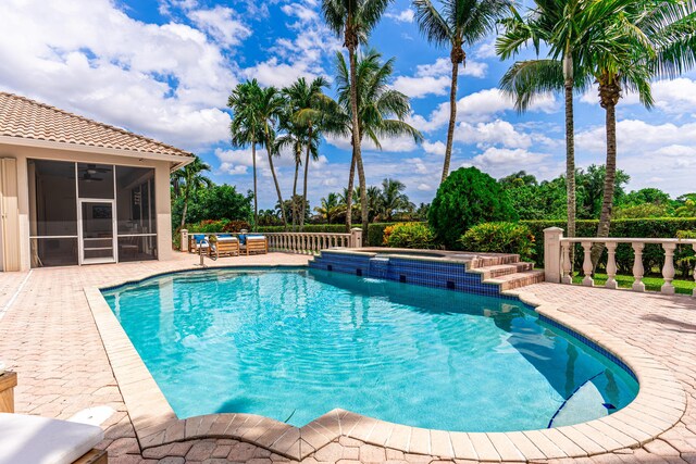 15495 Tall Oak Ave, Delray Beach, FL 33446 - view of pool featuring a patio, a sunroom, a fenced in pool, and an in ground hot tub