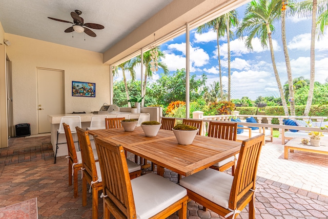 exterior space with ceiling fan and an outdoor kitchen