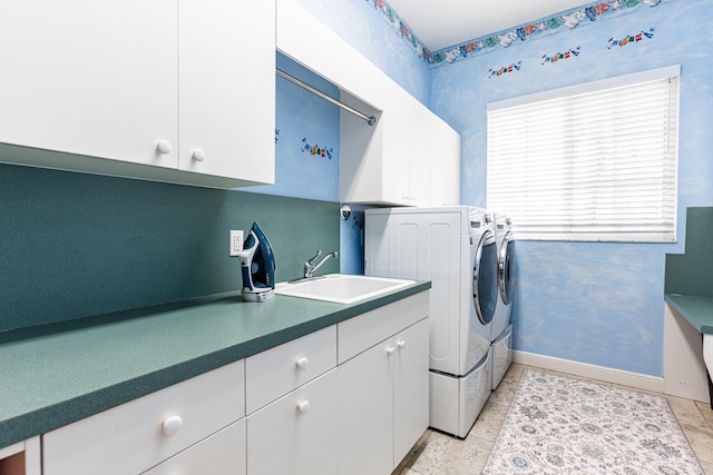 15495 Tall Oak Ave, Delray Beach, FL 33446 - laundry room featuring baseboards, washing machine and dryer, cabinet space, and a sink