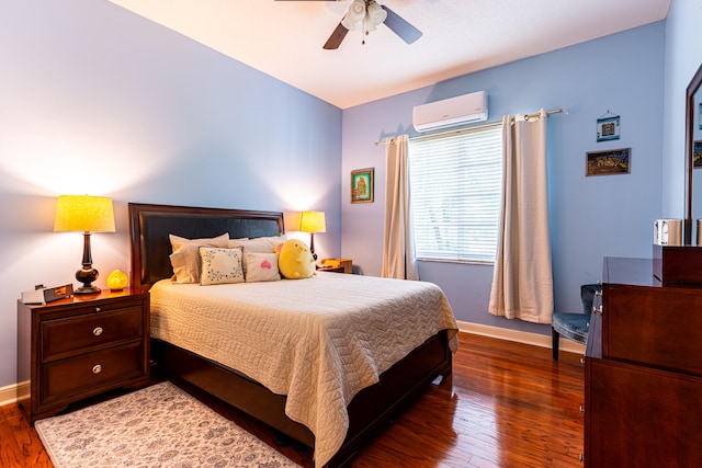 bedroom with a wall unit AC, ceiling fan, and dark hardwood / wood-style floors