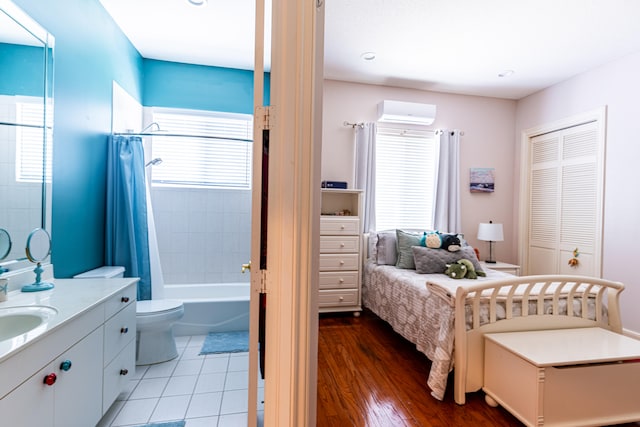 full bathroom with shower / tub combo, vanity, wood-type flooring, toilet, and a wall mounted air conditioner