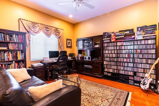 home office with ceiling fan and light hardwood / wood-style floors