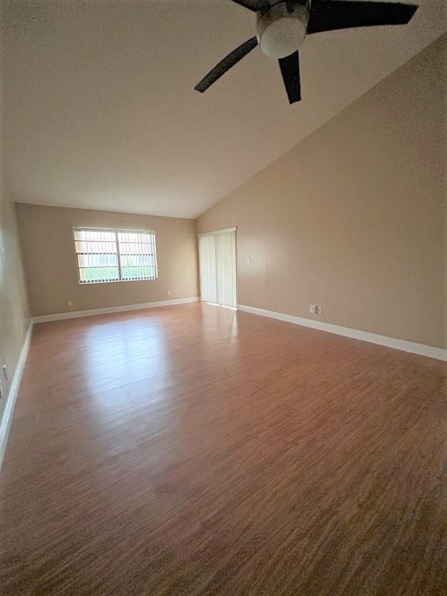 empty room with wood-type flooring, vaulted ceiling, and ceiling fan