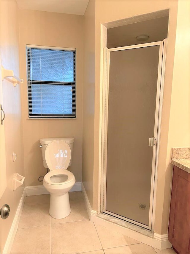 bathroom with walk in shower, tile patterned flooring, vanity, and toilet