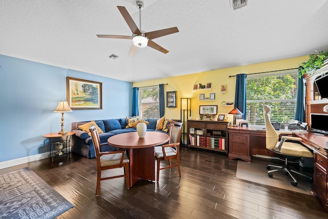 dining area featuring ceiling fan, a wealth of natural light, dark hardwood / wood-style floors, and a textured ceiling