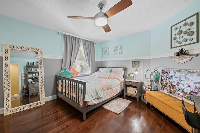 bedroom with dark hardwood / wood-style flooring, a textured ceiling, and ceiling fan