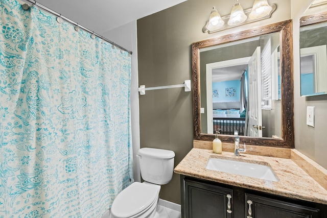 bathroom featuring toilet and vanity