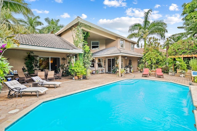 view of swimming pool with a patio area and pool water feature