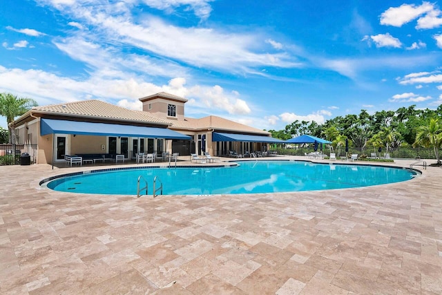 view of swimming pool featuring a patio area