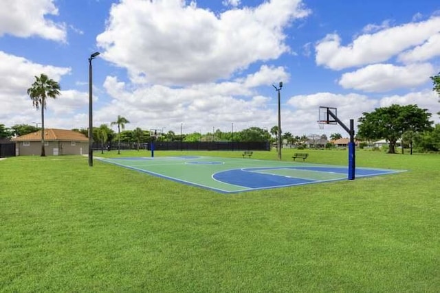 view of sport court featuring a lawn