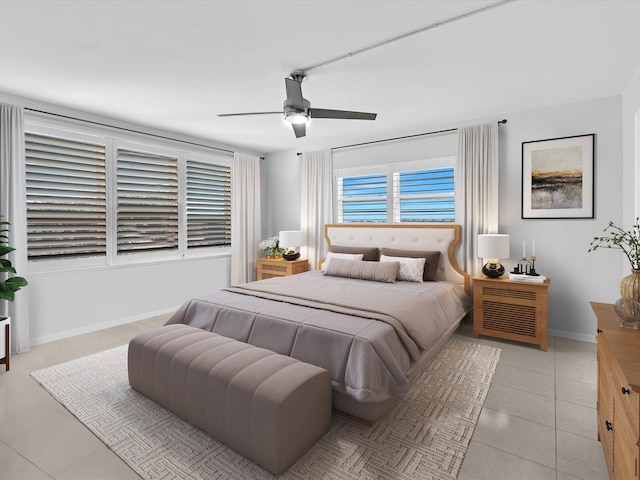 tiled bedroom featuring ceiling fan