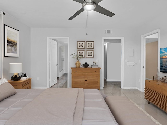 bedroom with ceiling fan, light tile patterned floors, and ensuite bathroom