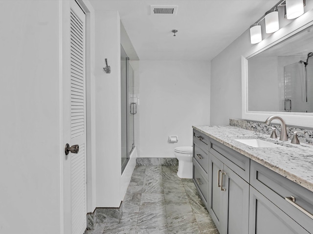 bathroom with vanity, toilet, and walk in shower