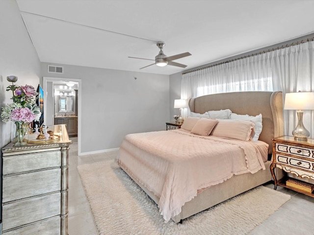 tiled bedroom with ceiling fan and ensuite bathroom