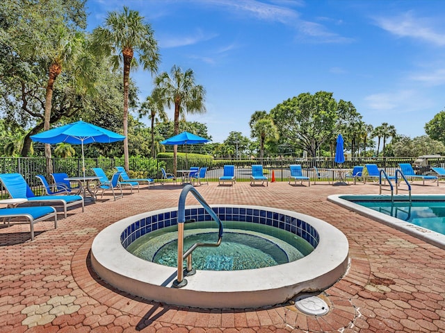 view of pool featuring a patio area and a community hot tub