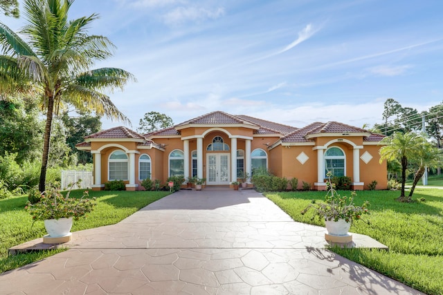 mediterranean / spanish-style house featuring a front yard