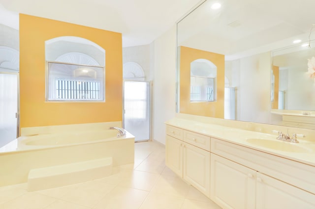 bathroom with independent shower and bath, vanity, and tile patterned floors