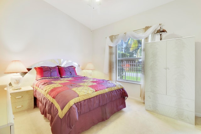 carpeted bedroom featuring vaulted ceiling