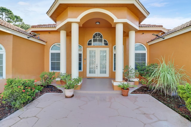 view of exterior entry featuring french doors