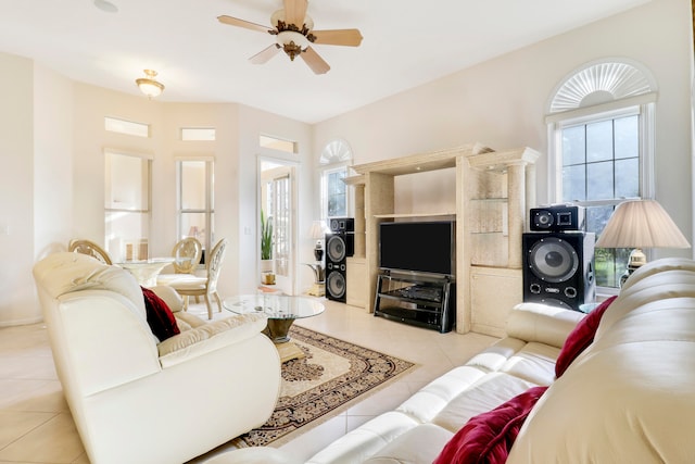 tiled living room with ceiling fan and plenty of natural light