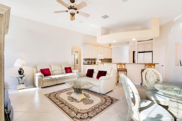 tiled living room with ceiling fan