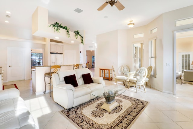 tiled living room featuring ceiling fan