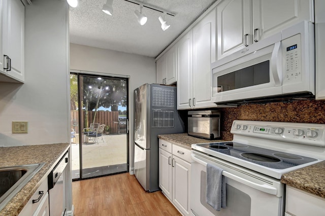 kitchen featuring a textured ceiling, white appliances, light wood-type flooring, and white cabinets