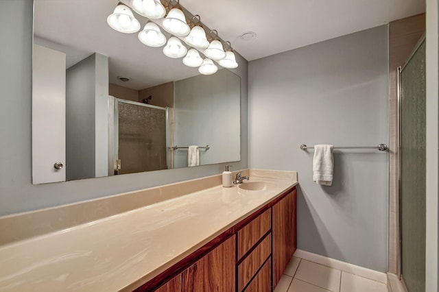 bathroom featuring tile patterned flooring, an enclosed shower, and vanity