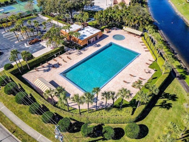 view of pool featuring a patio and a water view