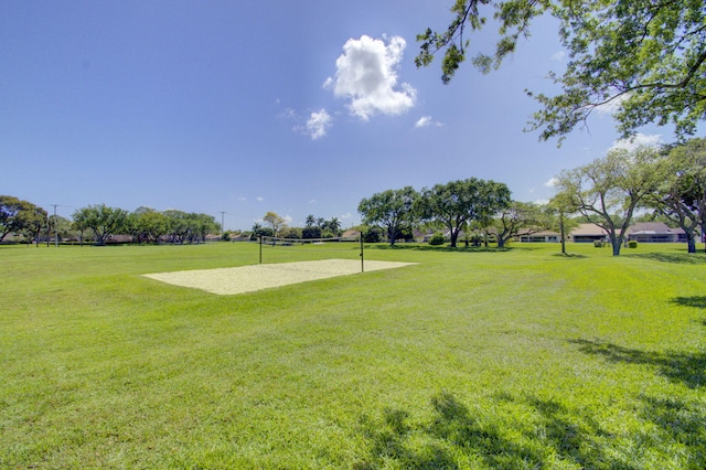 view of property's community featuring volleyball court and a yard