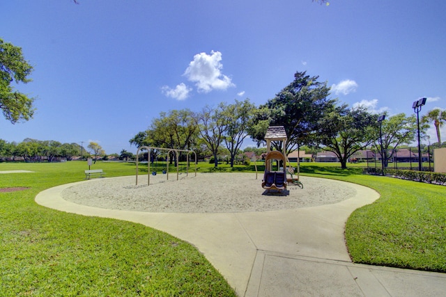 view of home's community featuring a lawn and a playground