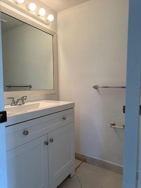 bathroom featuring tile patterned flooring and vanity